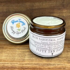 2 ounce jar of blue tansy whipped tallow with lid off